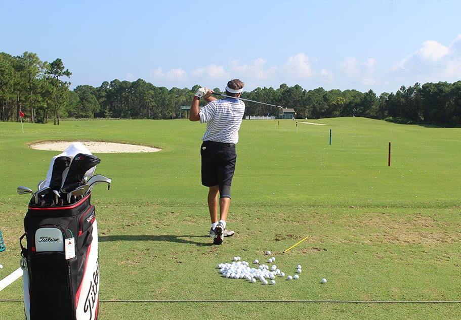 man taking a swing on the regatta bay golf course