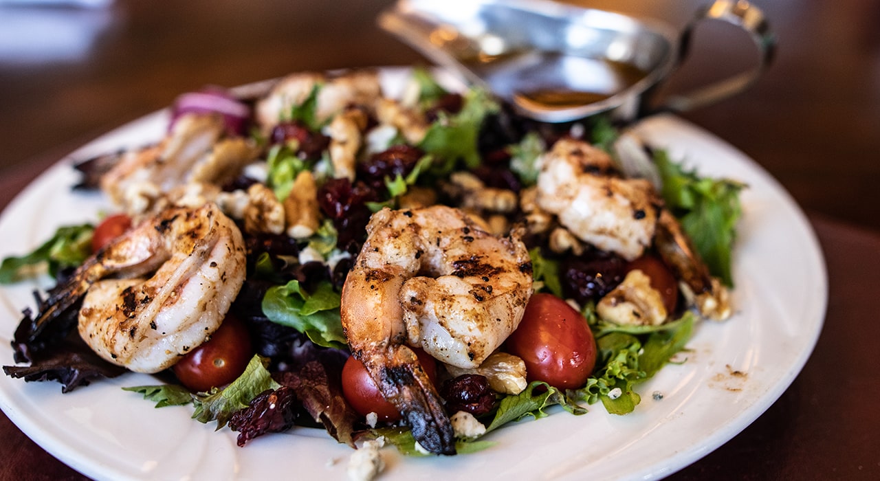 close up of a salad with shrimp on it