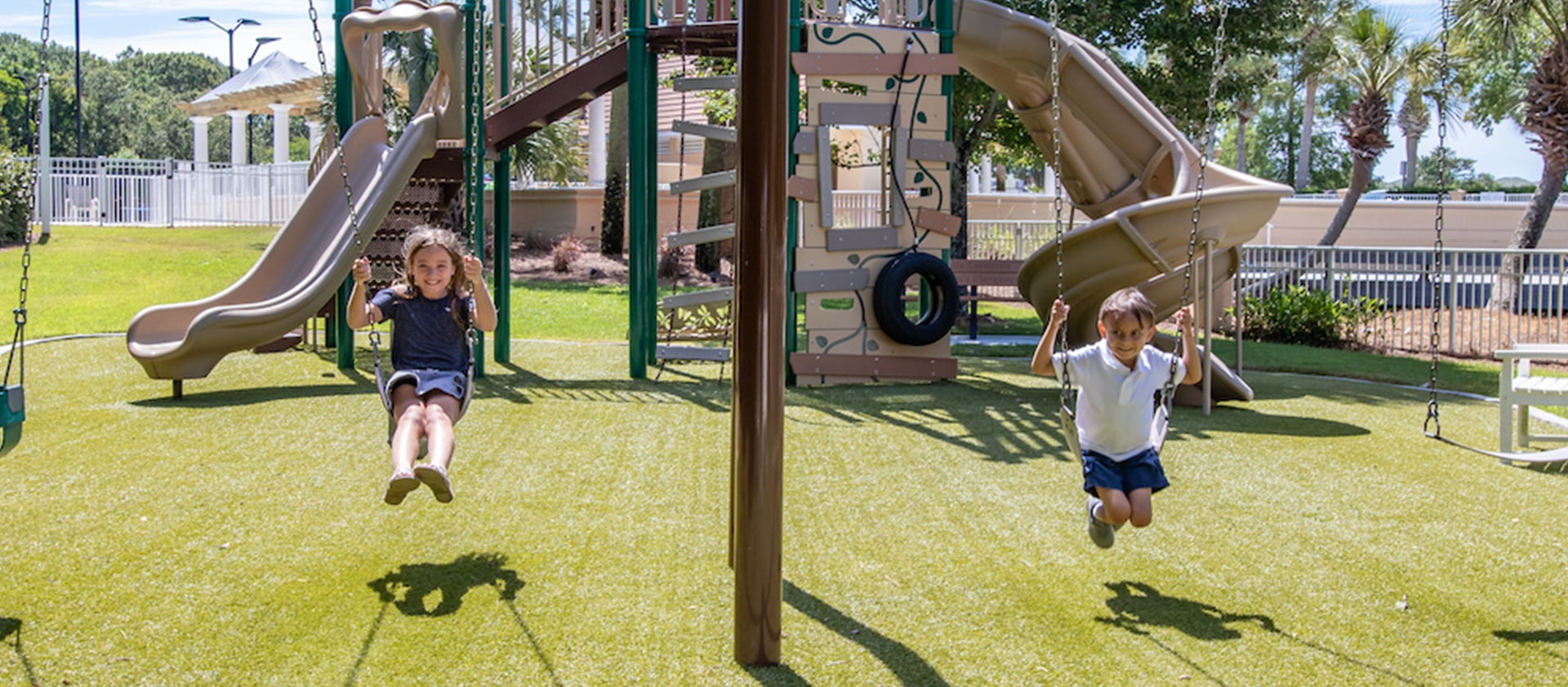 Children playing on swings at Regatta Bay playground